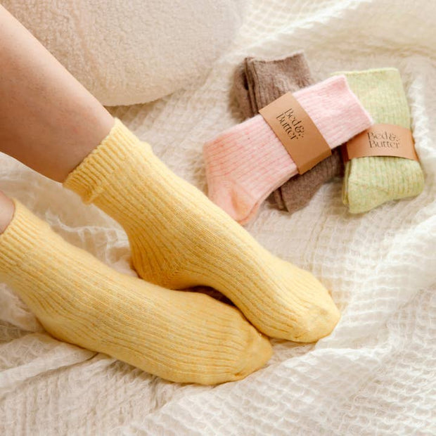 Soft ribbed yellow socks made from cashmere and recycled fibres