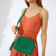 Emerald green vegan leather crossbody with tassel and adjustable strap