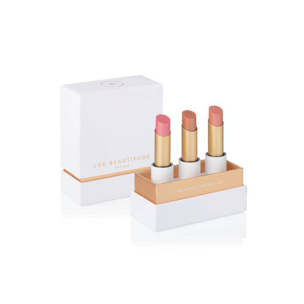 Guava Blush, Nude Sugar, and Chai Shimmer sheer lipsticks in eco-luxe packaging