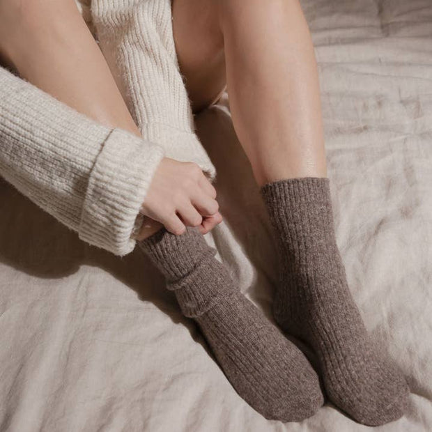 Bed and Butter The Comfiest Socks Light Chocolate cashmere wool ankle socks being put on