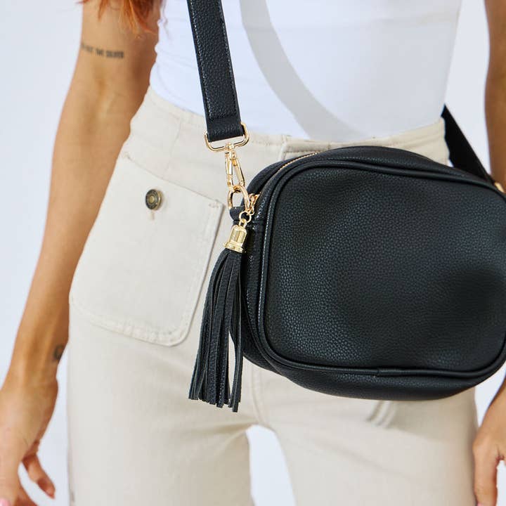 Black vegan leather crossbody with tassel and adjustable strap