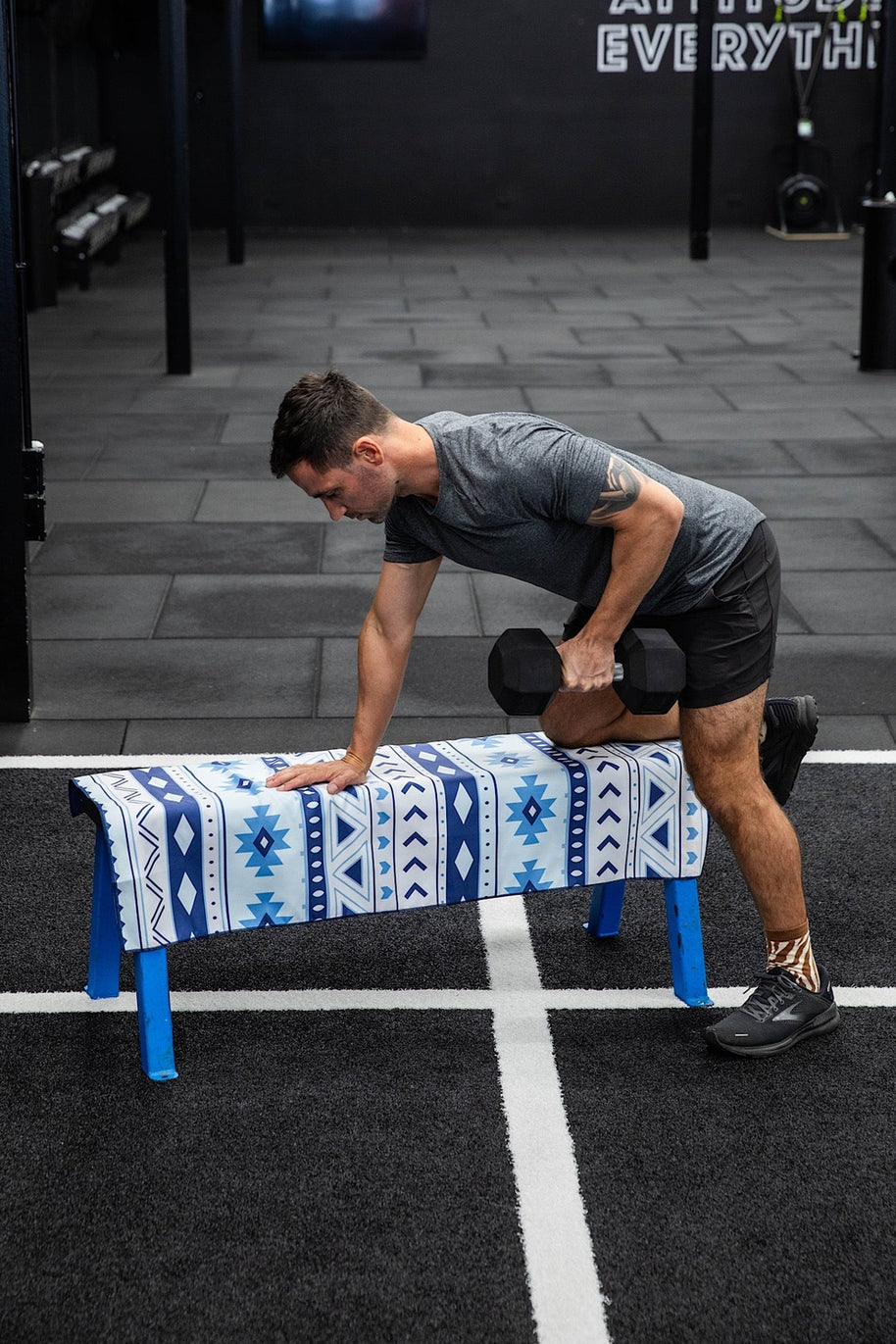 Man holding navy and white aztec print quick dry towel