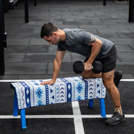 Man holding navy and white aztec print quick dry towel