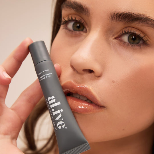 Peach-tinted lip butter with wild orange scent