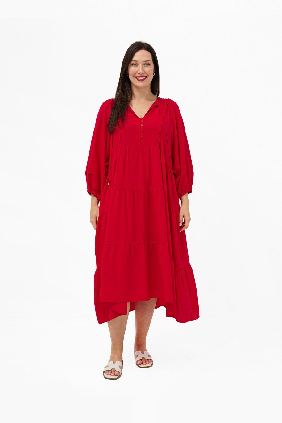 Model wearing the Mata Dress in Red featuring a tiered skirt, 3/4 sleeves and a relaxed oversized fit.