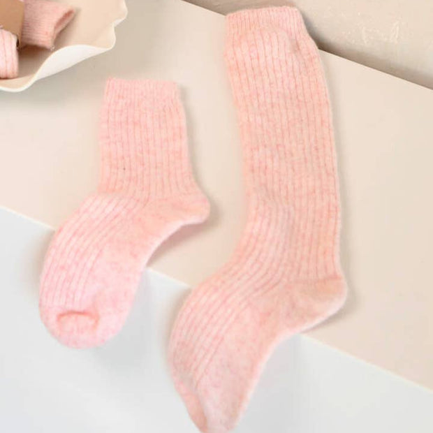 Bed and Butter cosy blush pink knee high socks styled against a clean white background