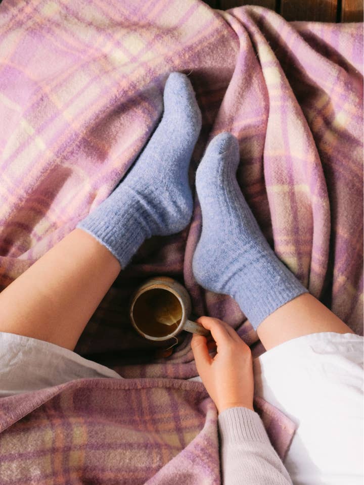 Bed and Butter cosy lavender ankle socks resting on waffle blanket