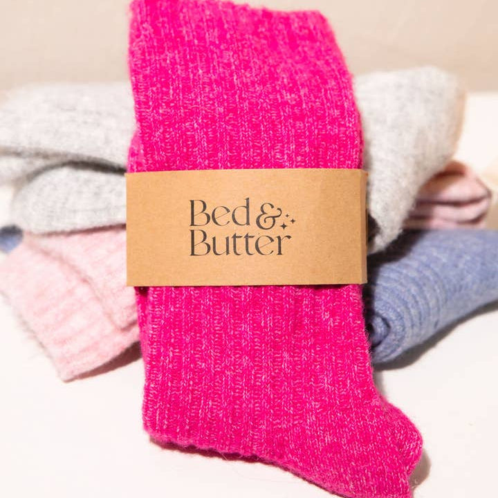 Bed and Butter light and airy fuchsia pink ankle socks worn against neutral background