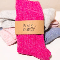 Bed and Butter light and airy fuchsia pink ankle socks worn against neutral background