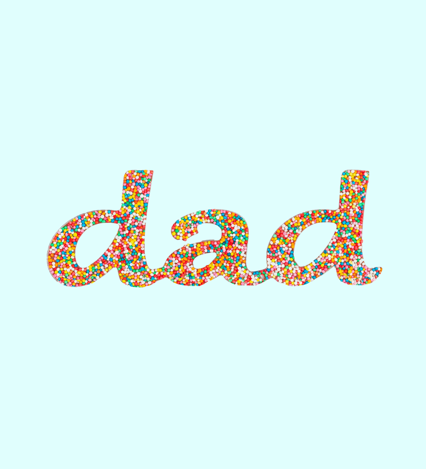 Belgian milk chocolate spelling DAD topped with rainbow sprinkles