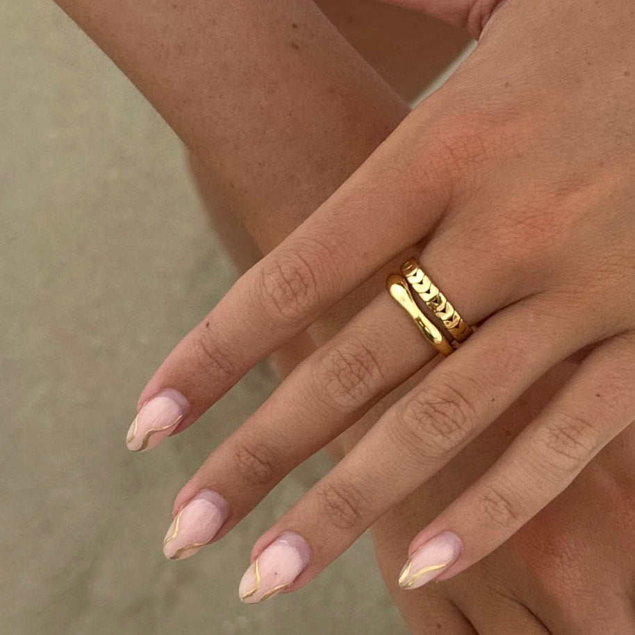 Gold chain link ring worn with activewear