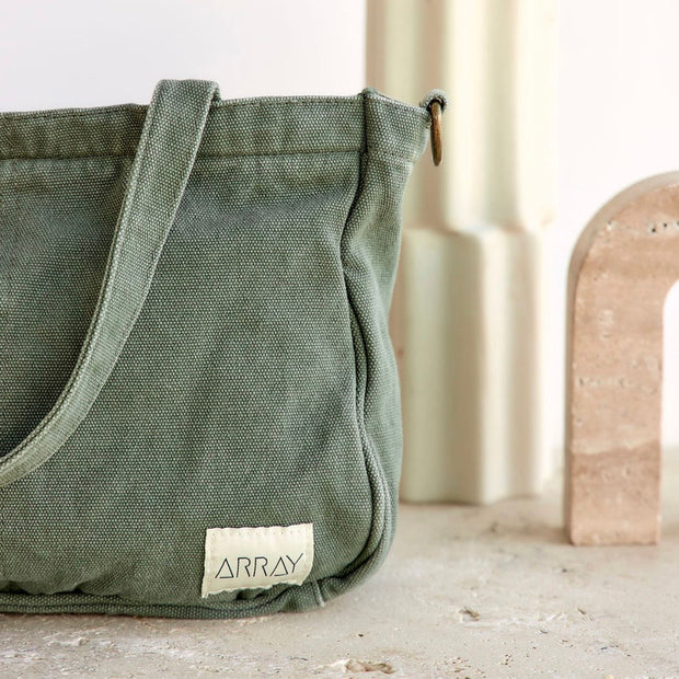 Compact six pocket cotton canvas mini tote with antique gold hardware
