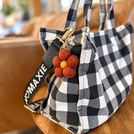 Deep Red Felt Flower Keychain attached to bag