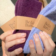 Deep wine coloured cosy socks folded in a stack with other colours