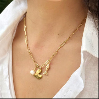 Delicate charm necklace featuring heart fish pendant and pearl accent