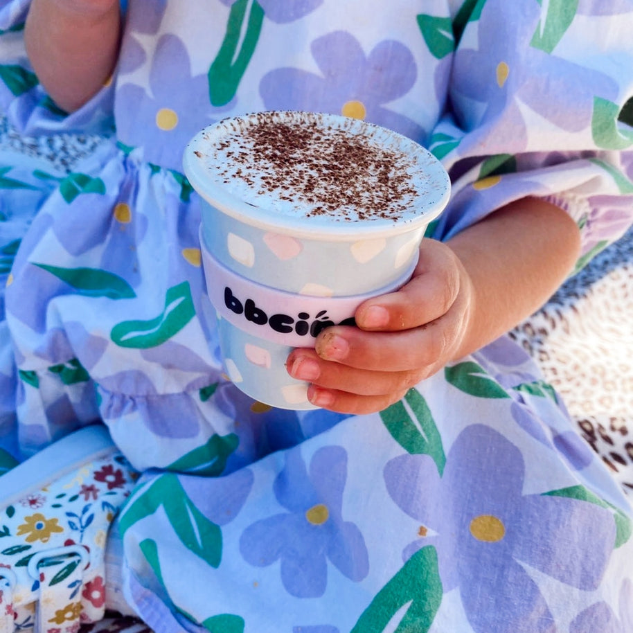 Eco-friendly bamboo kids cup with pastel marshmallow print on soft blue-grey background