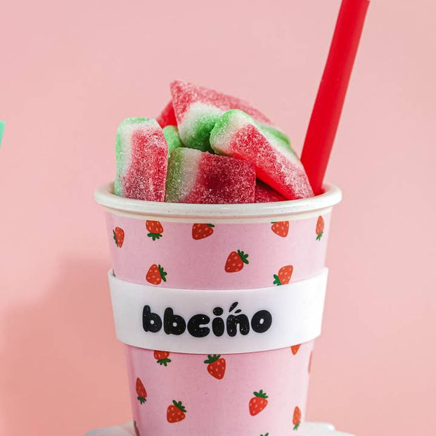 Eco-friendly bamboo kids cup with strawberry print on pink background