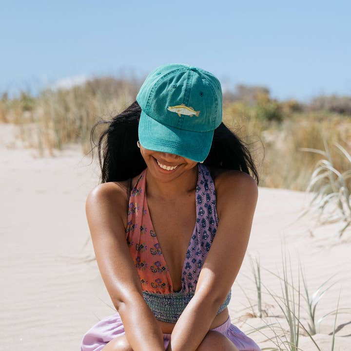 Embroidered barramundi fish detail on teal dad cap