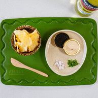 Green plastic-free chopping board with juice groove and non-slip grip