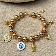 Gold hematite bracelet with clover, evil eye and garlic charms