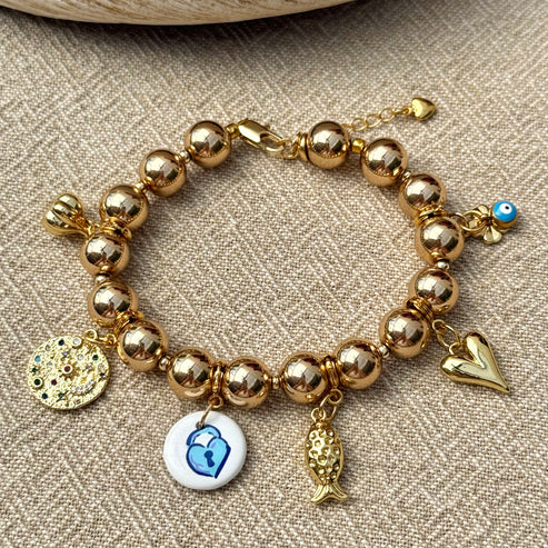 Gold hematite bracelet with clover, evil eye and garlic charms