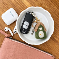 Green Felt House Keychain styled with keys on tray