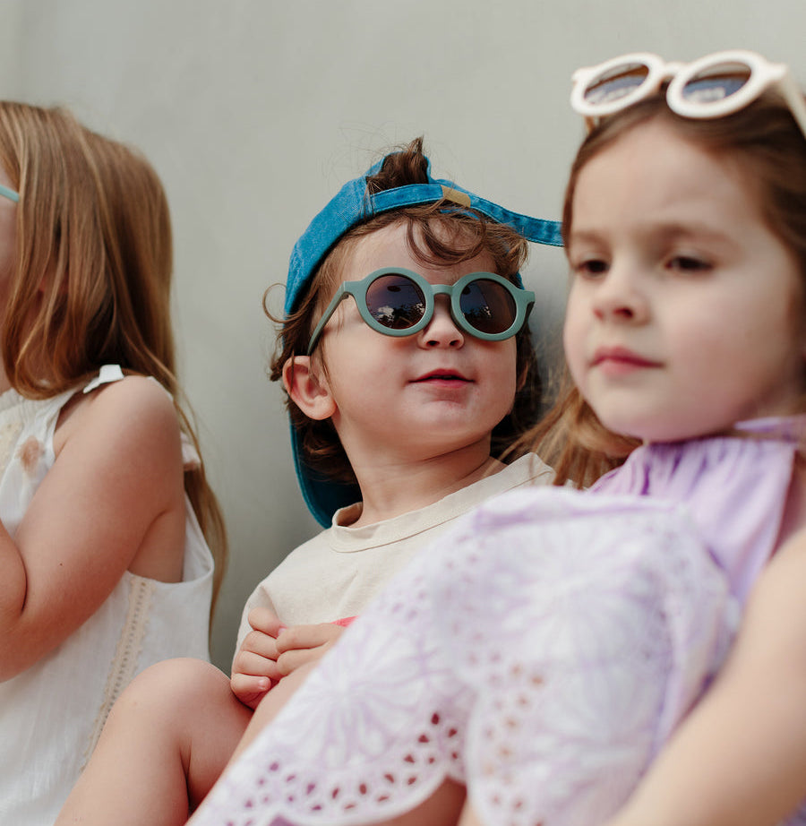 Sage green children’s sunglasses with round acrylic lenses
