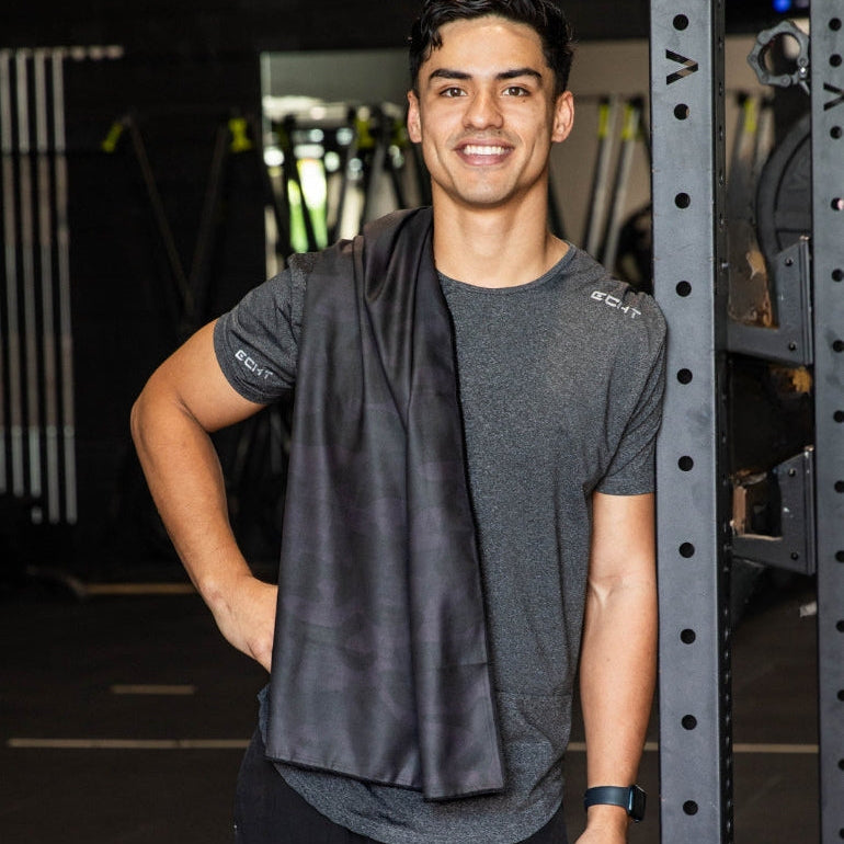 Man holding dark grey camo print quick dry towel