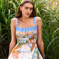 Model wearing the Midi Dress in Pastel Coast with a square neckline, elasticated waist and coastal print.