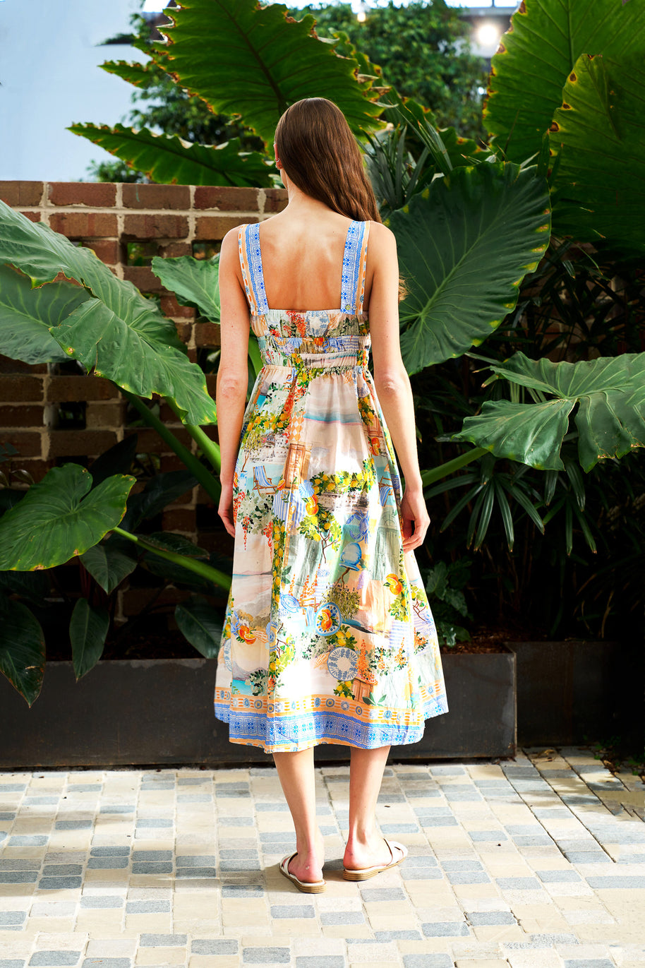 Model wearing the Midi Dress in Pastel Coast with a square neckline, elasticated waist and coastal print.