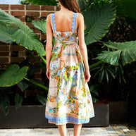 Model wearing the Midi Dress in Pastel Coast with a square neckline, elasticated waist and coastal print.