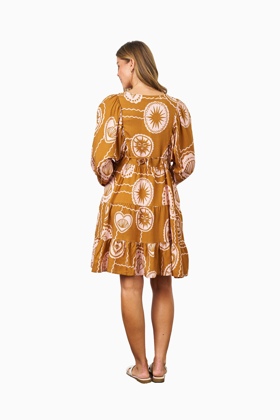 Model wearing the Aaliyah Dress in Brown Pink featuring a v-neckline, puff sleeves, tiered skirt and relaxed fit.