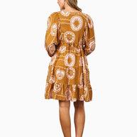 Model wearing the Aaliyah Dress in Brown Pink featuring a v-neckline, puff sleeves, tiered skirt and relaxed fit.