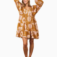 Model wearing the Aaliyah Dress in Brown Pink featuring a v-neckline, puff sleeves, tiered skirt and relaxed fit.