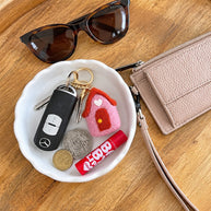 Pink Felt House Keychain styled with keys and wallet