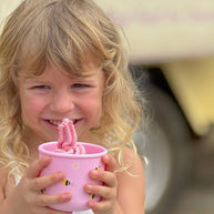 Reusable food-grade silicone kids snack pot with bumble bee illustration on pink background