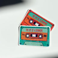 Green and orange cassette tape vinyl sticker by The Bright Co