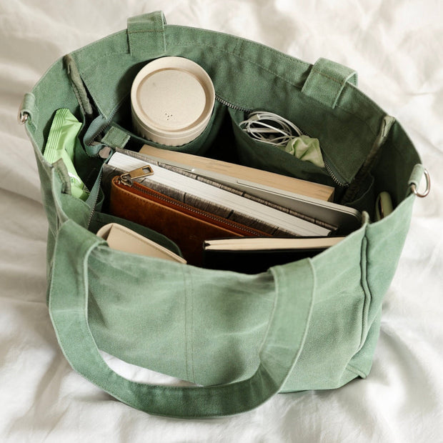 Six pocket cotton canvas tote bag with nickel silver hardware
