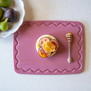 Small pink chopping board with non-slip grip