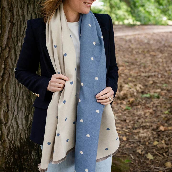 Soft reversible winter scarf with blue and cream heart pattern and frayed edges