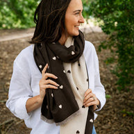 Soft reversible winter scarf with chocolate brown and cream heart pattern and frayed edges
