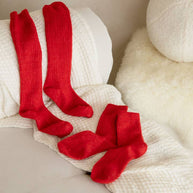 Soft ribbed red knee high socks made from cashmere and recycled fibres