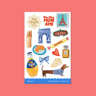 French travel stickers featuring croissant, Eiffel Tower, and perfume bottle
