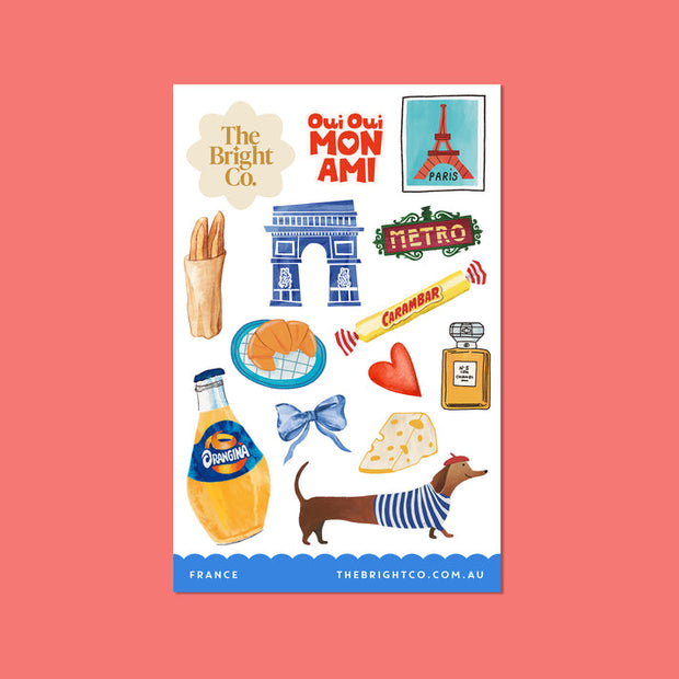 French travel stickers featuring croissant, Eiffel Tower, and perfume bottle