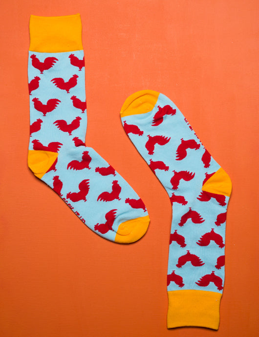 Sock It Up The Cock Sock with red rooster design on blue background