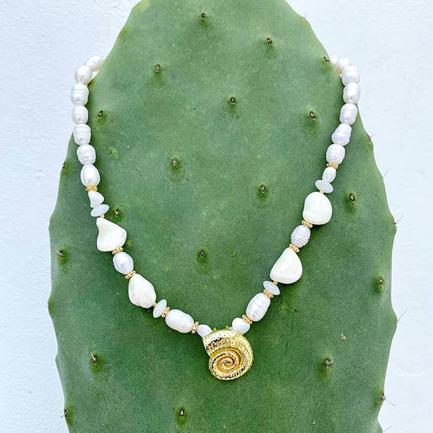 White gemstone and freshwater pearl beaded necklace with gold spiral shell centrepiece