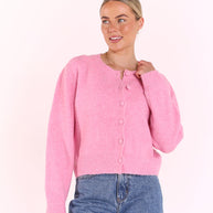 Woman wearing pink button down knit cardigan with ribbed hem