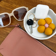 Yellow Felt Flower Keychain attached to bag