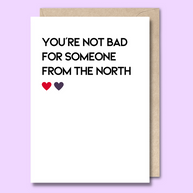 Unseasoned Greetings You’re Not Bad for Someone from the North card with red and purple hearts