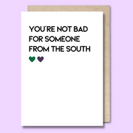 Unseasoned Greetings You’re Not Bad for Someone from the South card with green and purple hearts